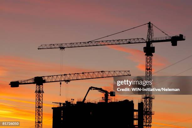 construction site at sunset - crane construction machinery stock pictures, royalty-free photos & images