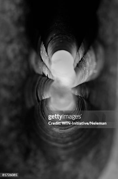 a coin lying in the long figured tunnel - copper tunnel stock pictures, royalty-free photos & images