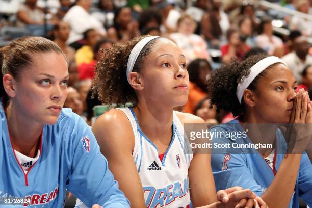 Kristen Mann, Jennifer Lacy and Chioma Nnamaka of the Atlanta Dream watch the action from the bench during the WNBA game against the Chicago Sky on...