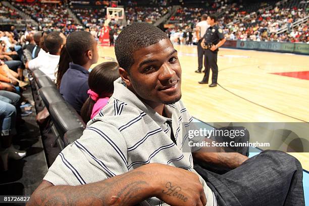 Josh Smith of the Atlanta Hawks sits courtside during the WNBA game against the Chicago Sky and Atlanta Dream on June 6, 2008 at Philips Arena in...