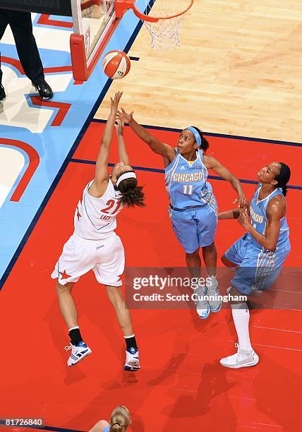 Jia Perkins of the Chicago Sky challenges the shot by Jennifer Lacy of the Atlanta Dream during the WNBA game on June 6, 2008 at Philips Arena in...