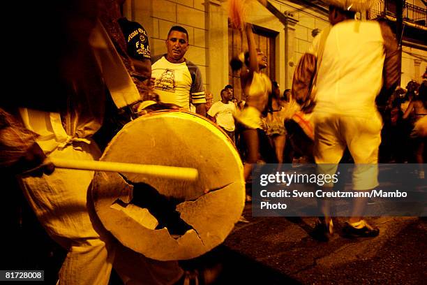 Cuban hits his broken drum as conga groups march through the streets during the Camaguey carnival June 24, 2008 in Camaguey, Cuba. The first day...