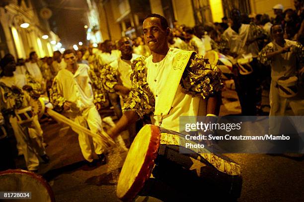 Cuban hits his drum with the Cuban flag painted on it, as conga groups march through the streets during the Camaguey carnival June 24, 2008 in...