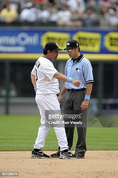 Manager Ozzie Guillen of the Chicago White Sox argues a call with 2nd base umpire James Hoye during the game against the Colorado Rockies at U.S....