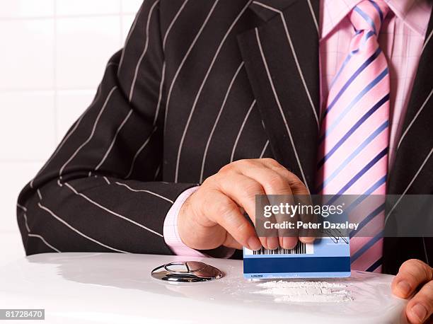 business man taking cocaine on toilet cistern. - cocaine stock pictures, royalty-free photos & images
