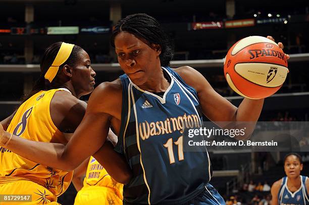 Taj McWilliams-Franklin of the Washington Mystics drives to the basket as DeLisha Milton-Jones of the Los Angeles Sparks guards on June 26, 2008 at...
