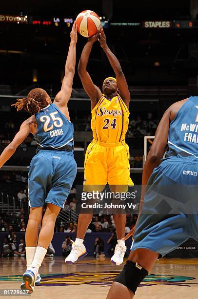 Marie Ferdinand-Harris of the Los Angeles Sparks has her shot contested by Monique Currie of the Washington Mystics during their game on June 26,...