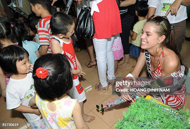 Miss Universe 2008 contestant Vera Krasova, Miss Russia plays with kids at Hanoi's SOS village on June 27, 2008. The contestants of Miss Universe...