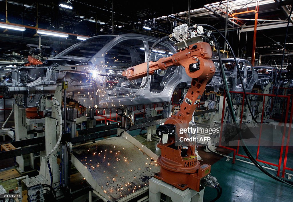 Robots weld car frames at a Proton assem