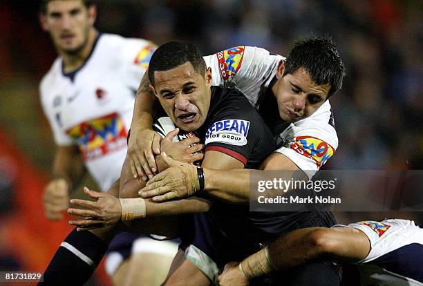 Corey Parker of the Broncos tackles Keith Peters of the Panthers during the round 16 NRL match between the Penrith Panthers and the Brisbane Broncos...