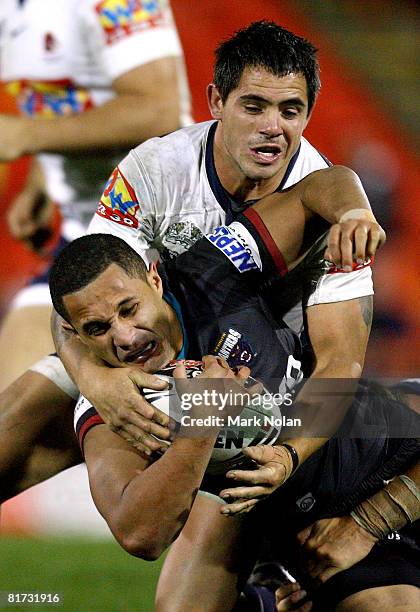 Corey Parker of the Broncos tackles Keith Peters of the Panthers during the round 16 NRL match between the Penrith Panthers and the Brisbane Broncos...