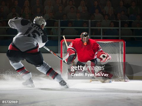 Ice hockey goalkeeper blocking a shot Ice hockey goalkeeper blocking a shot