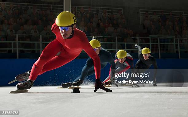 group of speed skaters racing - アイススケート ストックフォトと画像