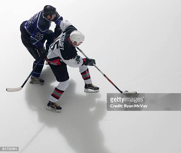 ice hockey player battling defender - ice hockey stock pictures, royalty-free photos & images