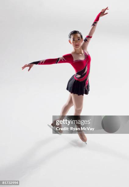 young woman figure skater standing in finishing pose. - ice skater stock pictures, royalty-free photos & images