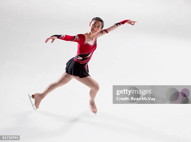 young woman figure skater standing in finishing pose. - figure skating day 14 stockfoto's en -beelden