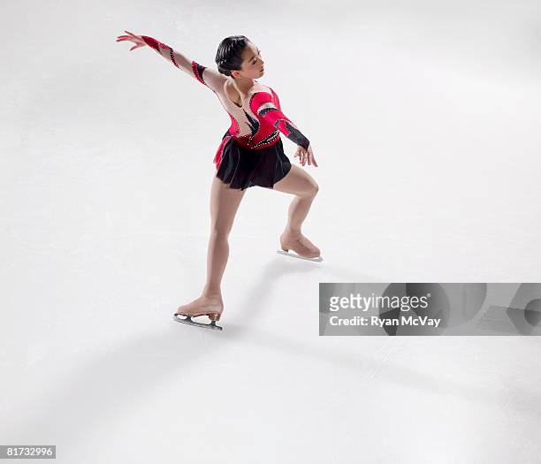 young woman figure skater skating - performing a bauer. - figure skating day 14 stockfoto's en -beelden
