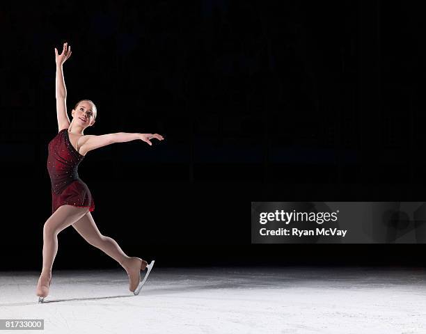 young woman figure skater standing in finishing pose. - ice skater stock pictures, royalty-free photos & images