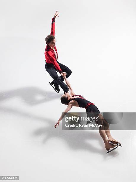 figure skating pair performing a death spiral - figure skating girl stock pictures, royalty-free photos & images