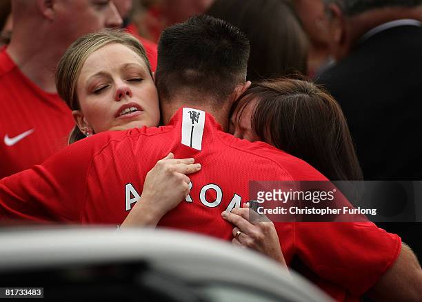 Mourners wear Manchester United football shirts bearing the names of brothers Arron Peak, ten years old and Ben Peak, eight years old, who were...