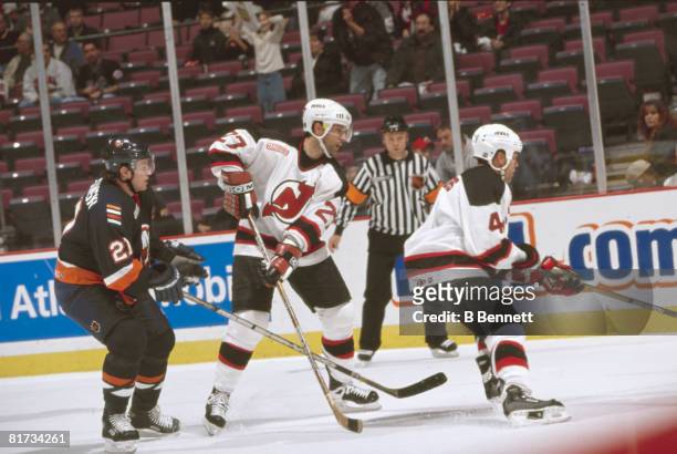 Threatened from behind by Polish ice hockey player Mariusz Czerkawski of the New York Islanders, Canadian teammates Scott Niedermayer and Scott...