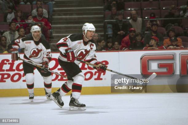 Trailed by fellow Canadian and teammate Scott Niedermayer , ice hockey player Scott Stevens of the New Jersey Devils skates on the ice during a game,...