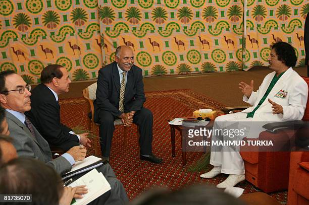 Libyan leader Moamer Kadhafi meets with Italy's Prime Minister Silvio Berlusconi in the presence of an unidentified translator in a tent in the port...