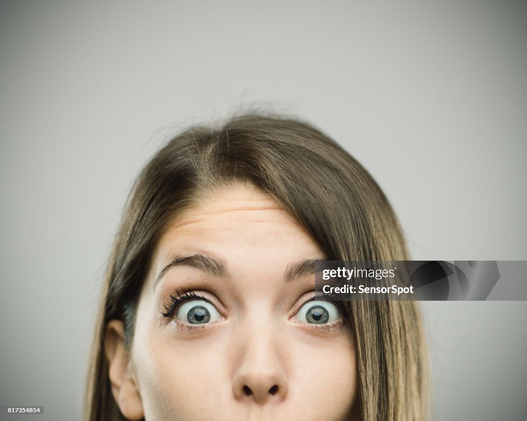 Close-up portrait of surprised beautiful young woman