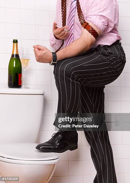 business man injecting heroin in bathroom. - heroin addict arm stock pictures, royalty-free photos & images