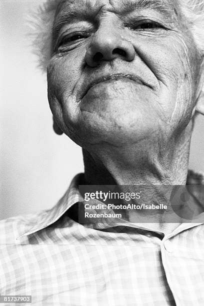 senior man, looking at camera, low angle view, black and white, portrait - smirking stock pictures, royalty-free photos & images