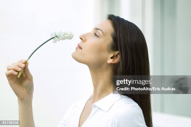 woman smelling flower, head back, side view - head back stock pictures, royalty-free photos & images