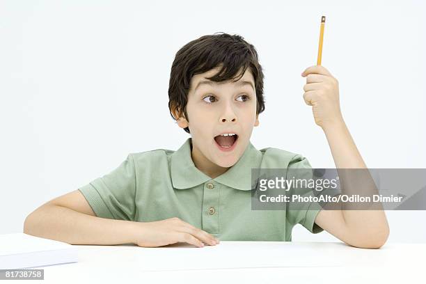excited boy holding up pencil, mouth wide open - boy holding picture cut out stockfoto's en -beelden