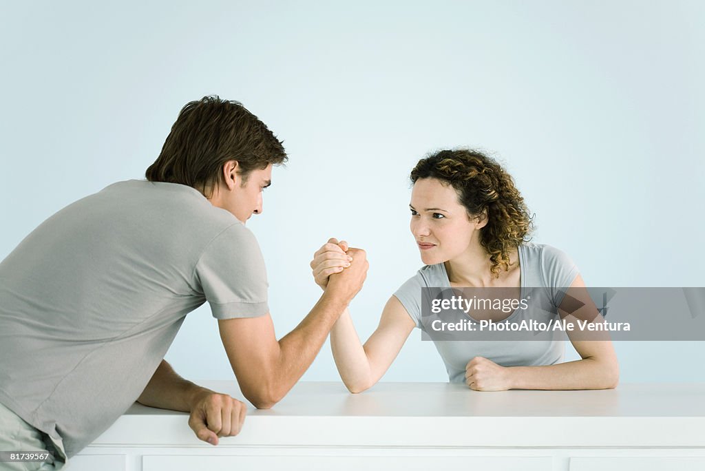 Couple arm wrestling together
