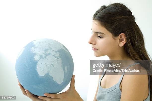 teenage girl holding globe, side view, portrait - holding globe imagens e fotografias de stock