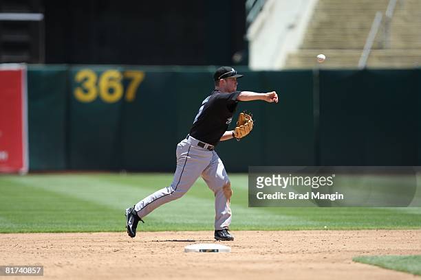 Aaron Hill of the Toronto Blue Jays throws to first base during the game against the Oakland Athletics at the McAfee Coliseum in Oakland, California...