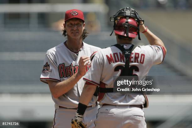 Randy Johnson of the Arizona Diamondbacks talks with teammate Miguel Montero during the game against the Pittsburgh Pirates at PNC Park in...