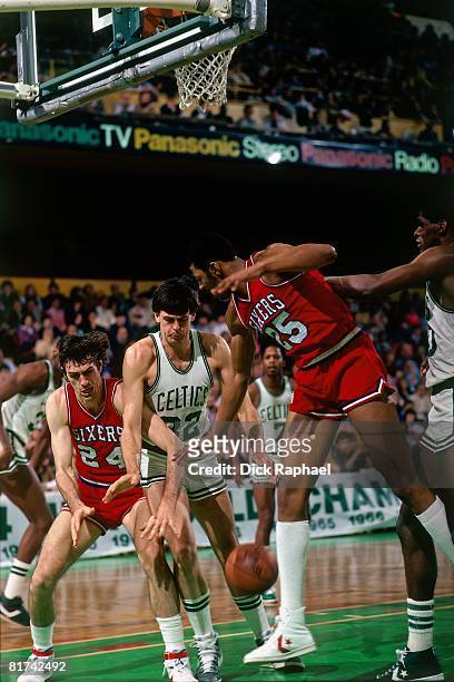 Bobby Jones of the Philadelphia 76ers battles for the loose ball against Kevin McHale of the Boston Celtics during a game played in 1983 at the...
