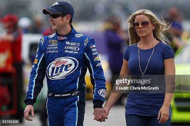 Kurt Busch, driver of the Miller Lite Dodge, walks down pit road with wife Eva during qualifying for the NASCAR Sprint Cup Series LENOX Industrial...