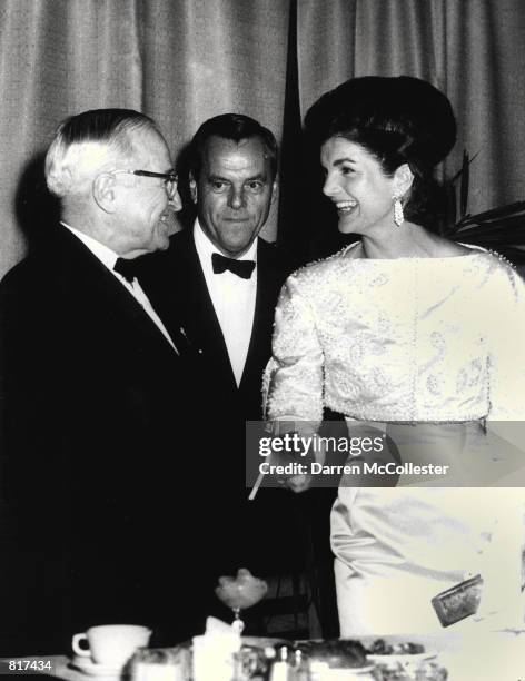 Jacqueline Kennedy attends a dinner for Harry Truman, whose hand she shakes January 20, 1962 at the National Guard Armory in Washington D.C.