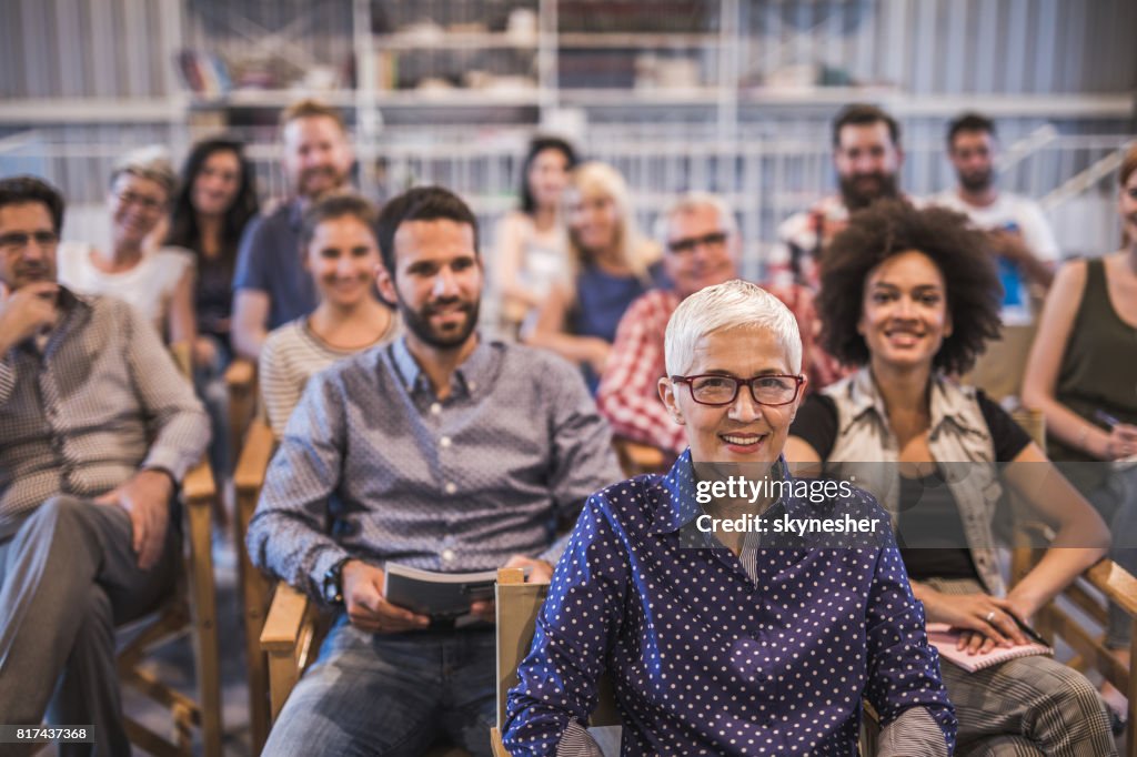 Large group of happy business people attending a seminar.