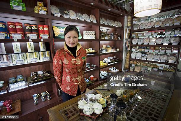 Woman working in tea shop near the Yu Garden Bazaar Market, Shanghai, China