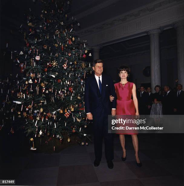 Jacqeuline Kennedy and her husband, President John F. Kennedy attend a White House staff Christmas Party December 1962 in Washington DC.