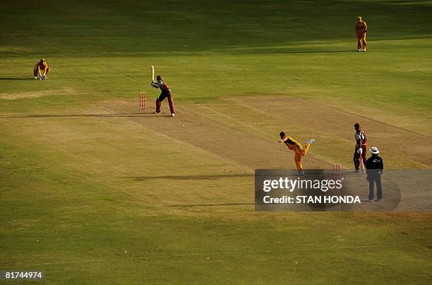 Australian cricketer James Hopes delivers to West Indies batsman Daren Powell June 27, 2008 in the late afternoon at National Stadium in St. Georges,...