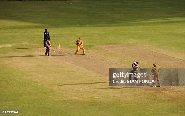 West Indies cricketer Daren Powell hits a six off Australia cricketer Michael Clarke June 27, 2008 in the late afternoon at National Stadium in St....