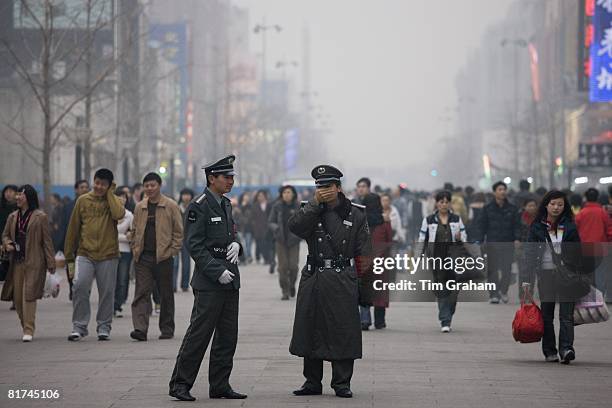 Chinese policemen on Wangfujing street of Central Beijing, China