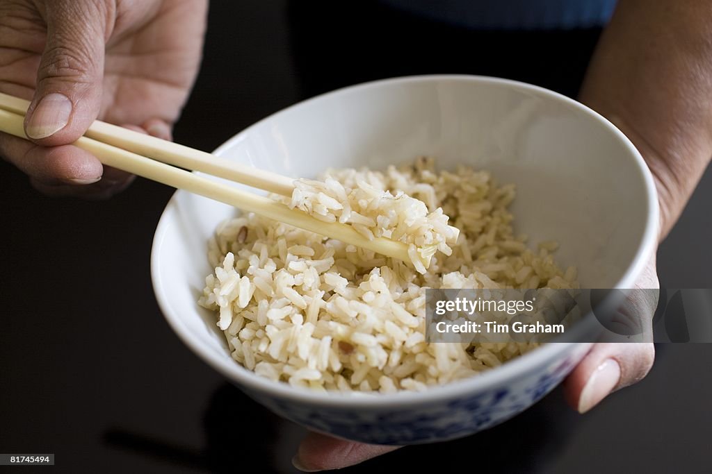 Bowl of Brown Wholegrain Rice & Chopsticks