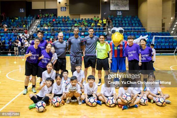 Crystal Palace players Ruben Loftus-Cheek, Scott Dann, Gary Mulcahey, the football club's mascot pose for a photo with the young soccer fans during...