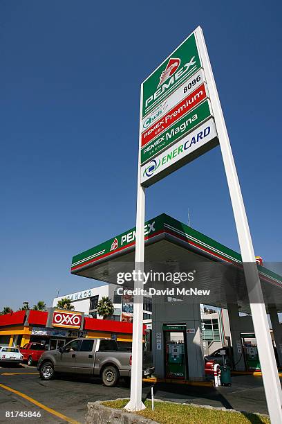 Car pull in and out of a Pemex gas station on June 27, 2008 in Tijuana, Mexico. With the cost of gasoline in California around $4.60 per gallon, many...