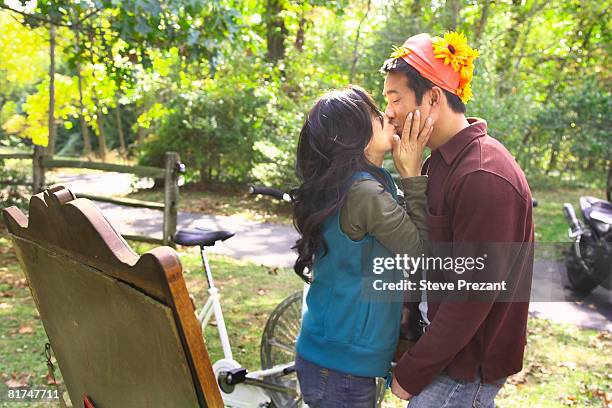 couple kissing at garage sale - steve prezant stock pictures, royalty-free photos & images