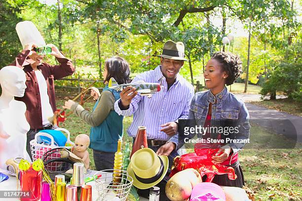 couples at garage sale - steve prezant stock pictures, royalty-free photos & images